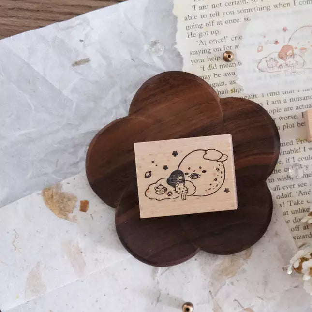Flower-shaped Hello Moon Rubber Stamp displayed on a textured paper background, close-up