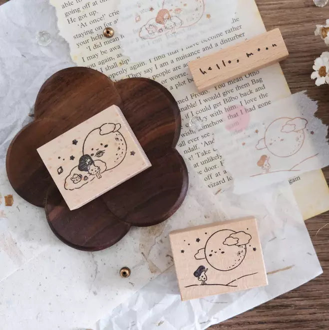 Set of Hello Moon rubber stamps with cute moon-themed designs on a textured paper backdrop