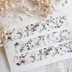 Floral-patterned paper with dried flowers on a light background