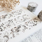 Floral patterned paper with dried flowers on a white surface