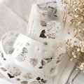 Floral-patterned soap bars on a textured surface with dried flowers.