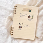 Notebook with shopping list on a soft fabric background