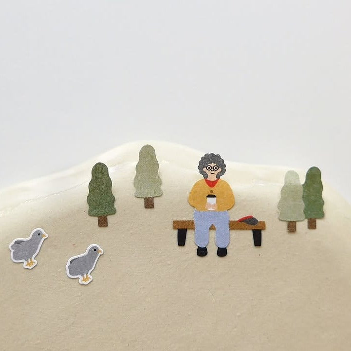Illustration of a person sitting on a bench with trees and birds in the foreground.