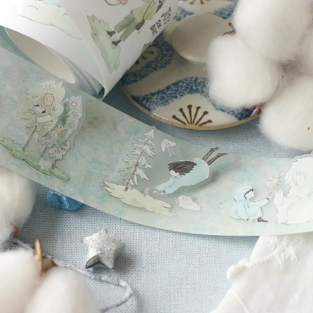 Decorative tape with nature-themed illustrations on a surface with cotton balls.