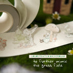 Decorative paper cutouts of nature-themed figures on a grassy background with text overlay.