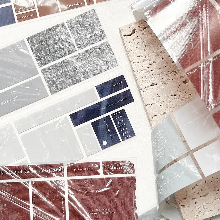 Textured tag designs from the Clear Tag PET Tape in varied colors and patterns on a white backdrop
