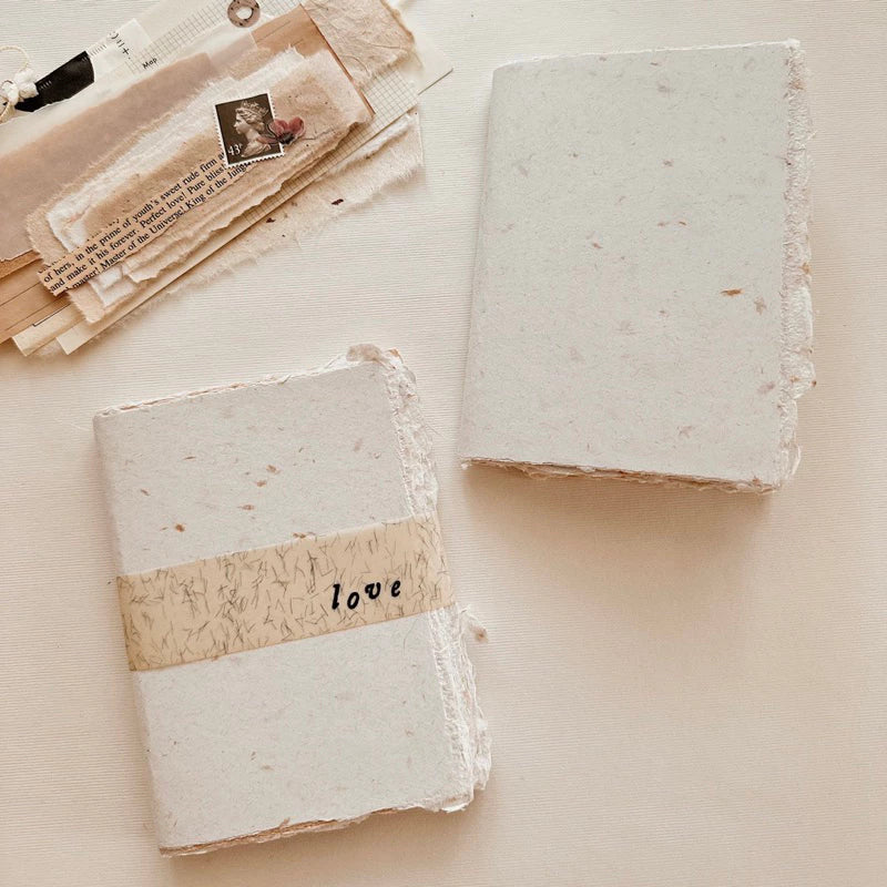 Two square blocks of soap with a 'love' band on a light background