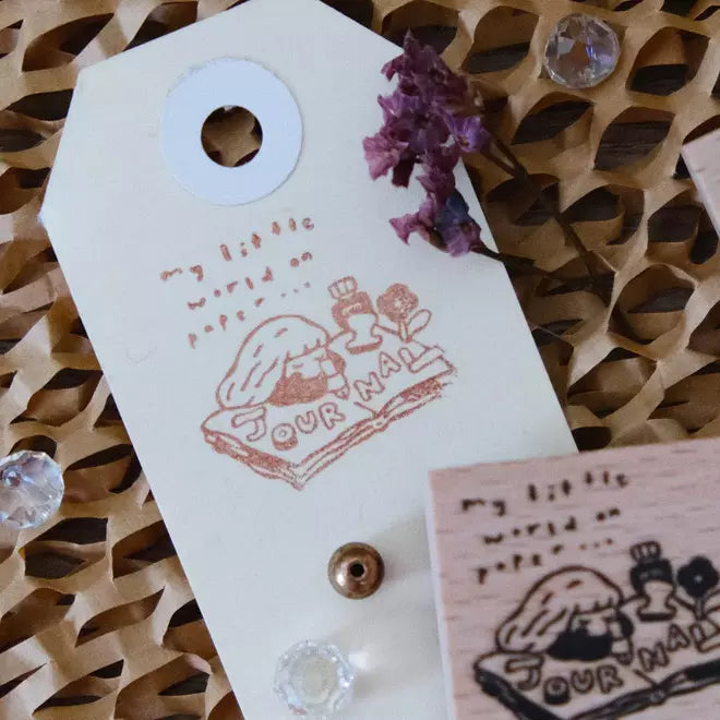 My World on Paper Journaling Girl stamp print on a white tag against textured brown paper