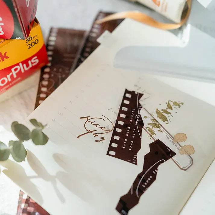 Notebook cover decorated with Film PET Tape film strips, Kodak film box visible in the background