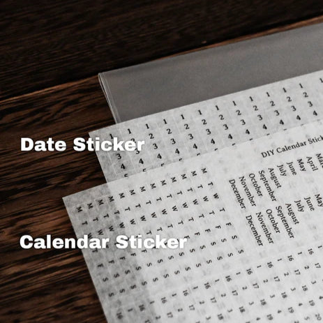 Included washi sticker sheets for months, weekdays and dates from the Anytime Anywhere Journal, laid out on a wooden desk