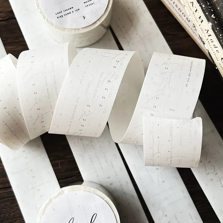 Rolls of Cloud Washi Tape showing grey layered print designs on a wooden surface, overhead view