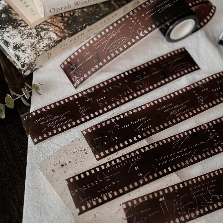Film strip sections of the Film PET Tape with retro text laid across a textured journaling surface