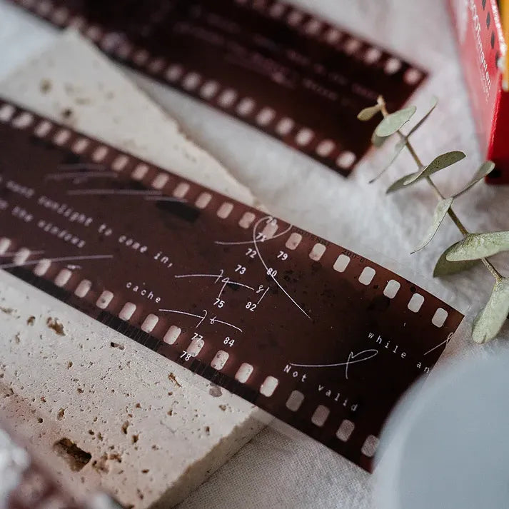 Close-up of Film PET Tape showing a film strip design with printed text on a textured craft backdrop