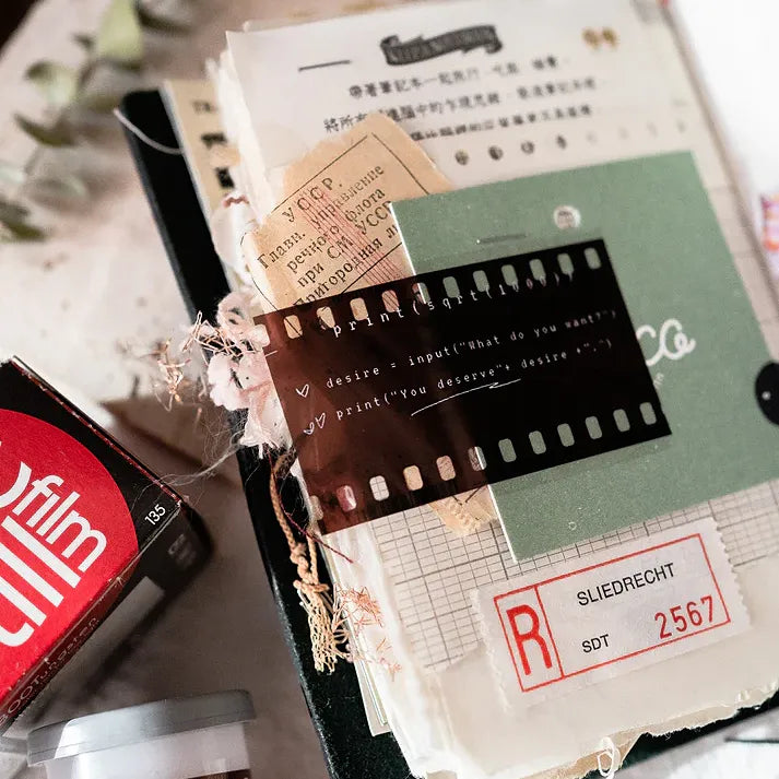 Film PET Tape by Jr. Journal styled with a film reel and vintage-style documents on a textured surface