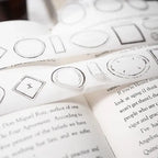 Sheet of black and white geometric stickers on an open book