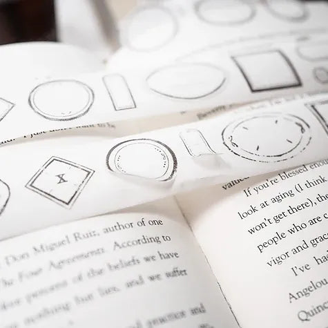 Sheet of black and white Label Washi Tape geometric label designs styled on an open vintage book
