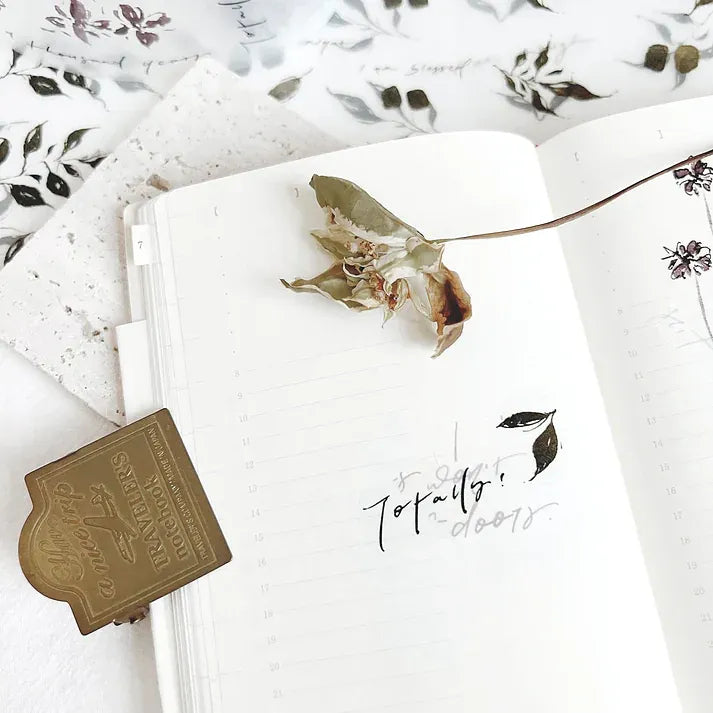 Leaves PET Tape by Jr. Journal styled on a notebook with a pressed flower and floral patterns around