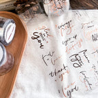White paper with handwritten text on a wooden surface
