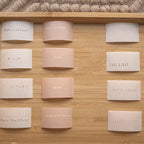 Motivational cards with phrases like 'Take a shower', 'Knit', 'Cook', etc., on a wooden shelf.