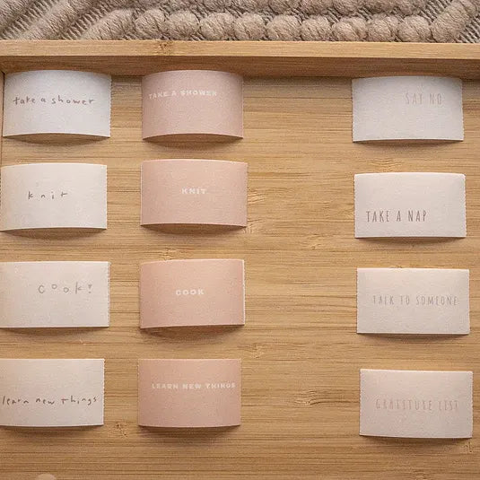 Healer Washi Tape self-care cards with phrases like Take a shower and Cook on a wooden shelf