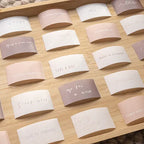 Set of small paper cards with motivational phrases on a wooden surface