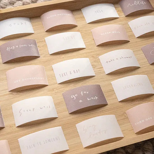 Small Healer Washi Tape cards with gentle phrases laid out together on a warm wooden surface