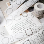 Decorative washi tape with geometric designs on a book page