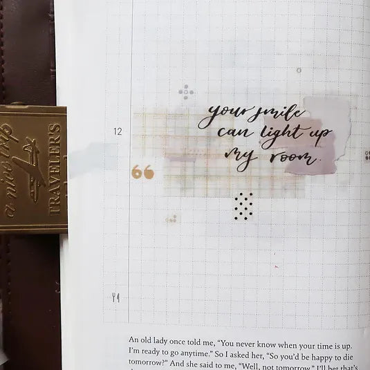 Notebook page decorated with Latte PET Tape script your smile can light up my room and a gold pen
