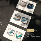 Set of six ceramic pouches on cards with 'ki tsugi' branding, displayed on a dark surface.