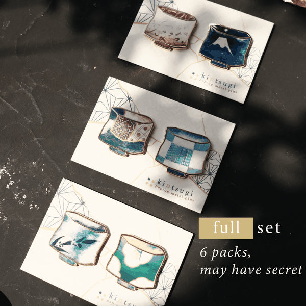 Set of six ceramic pouches on cards with 'ki tsugi' branding, displayed on a dark surface.