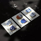 Set of decorative pins on a dark surface with water reflections