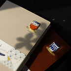 Close-up of a beige passport holder with a decorative emblem on a dark surface.