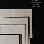 Set of lined and grid paper sheets on a black background