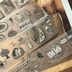 Set of decorative stamps with various designs on a clear sheet.