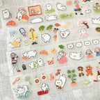 Kawaii sticker sheet with small dog faces, girl illustrations, camera, basket, and cozy lifestyle elements in pastel tones.