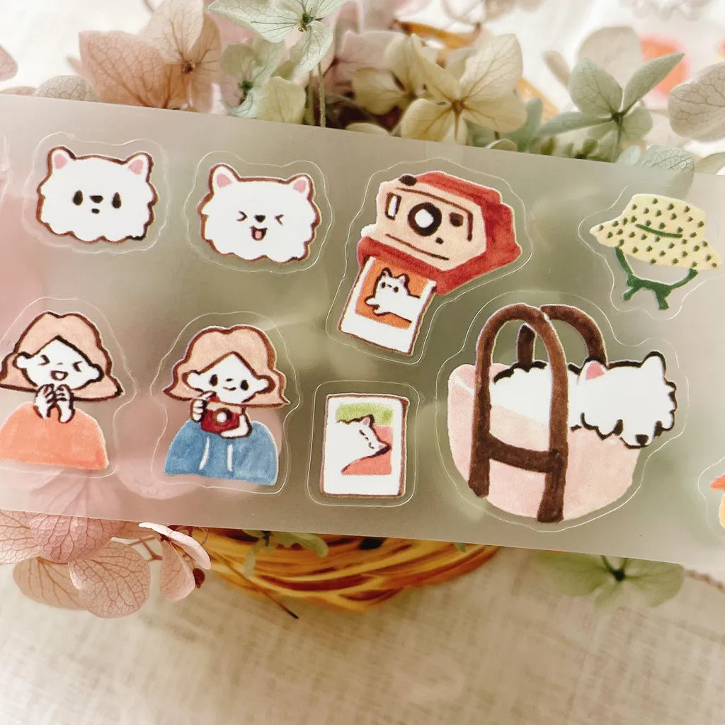 Kome-Chan Cut PET Tape roll displayed with its dog and character stickers spread out