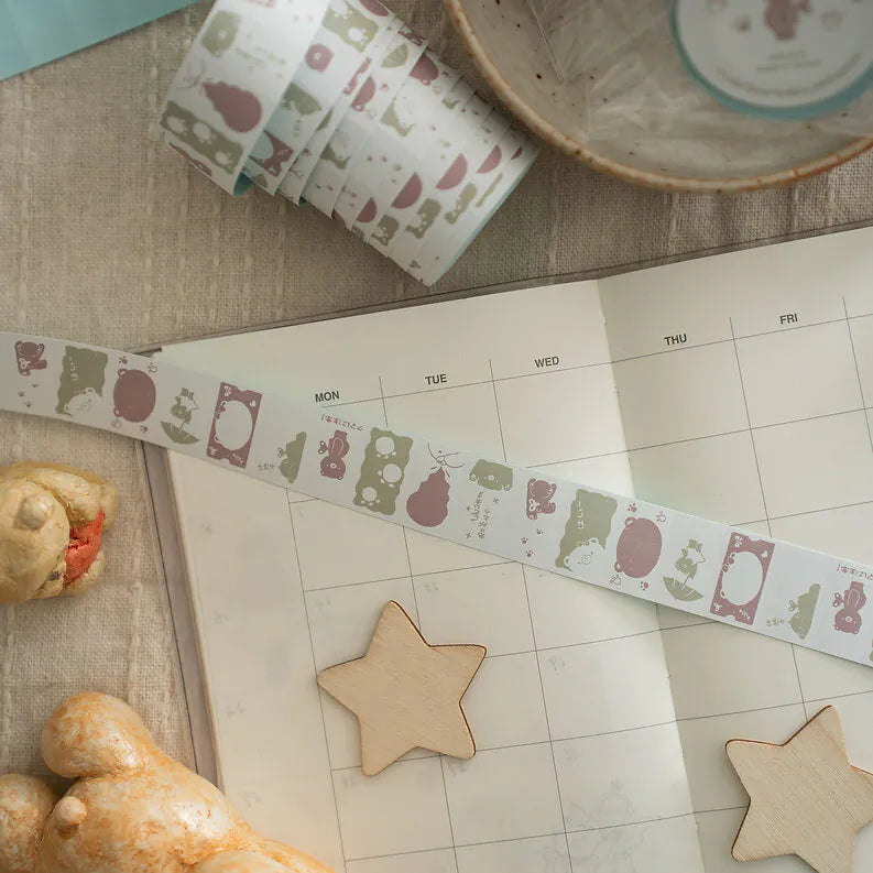 Kuma Label Sticker Tape animal patterns on a calendar styled with wooden stars and a pastry