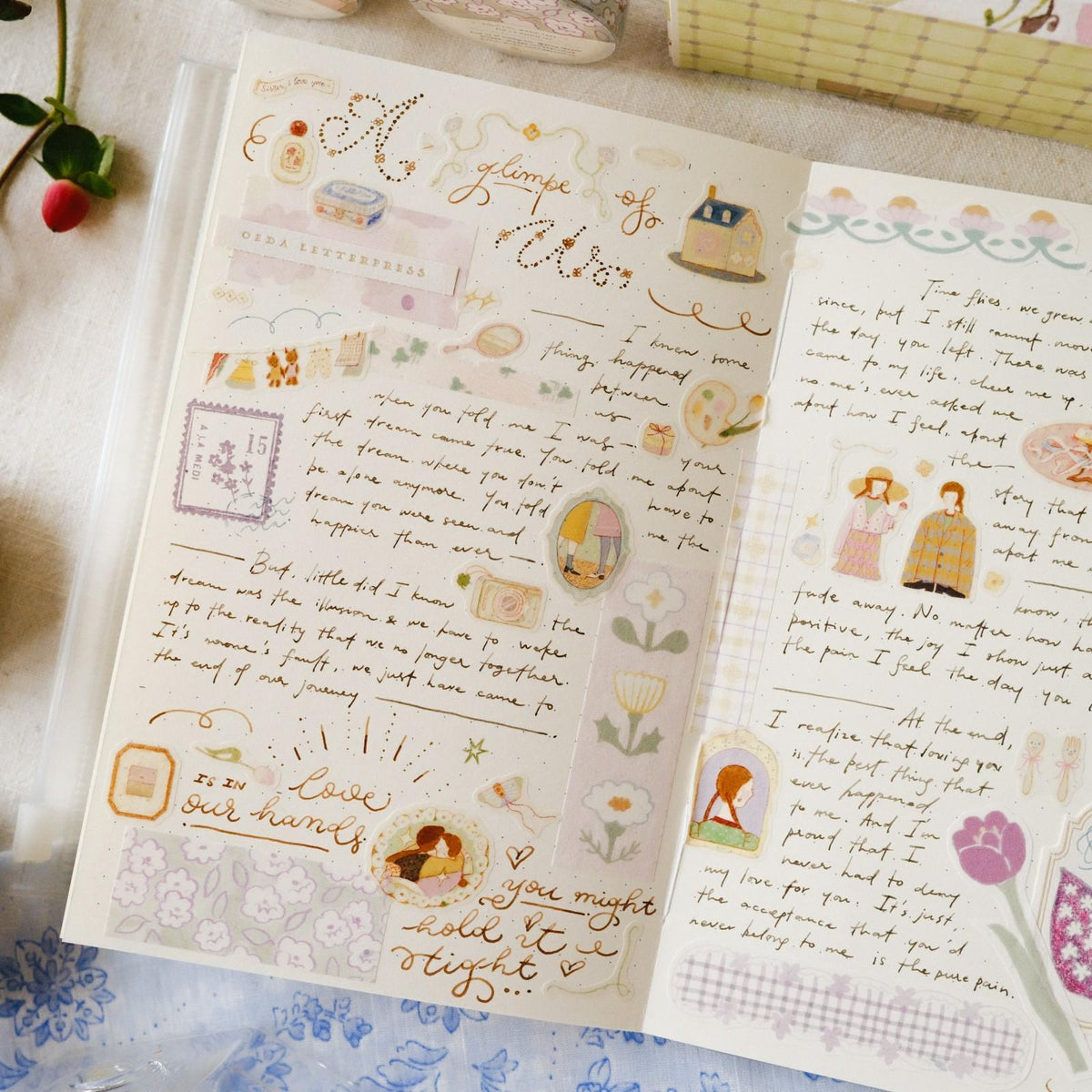 Open book with decorative text and illustrations on a textured surface