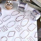 Clear jewelry display stands on a white surface with books and a stuffed giraffe in the background.