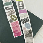 Two strips of decorative stickers with various designs on a dark surface.