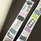 Sheet of decorative stickers with various designs on a dark surface