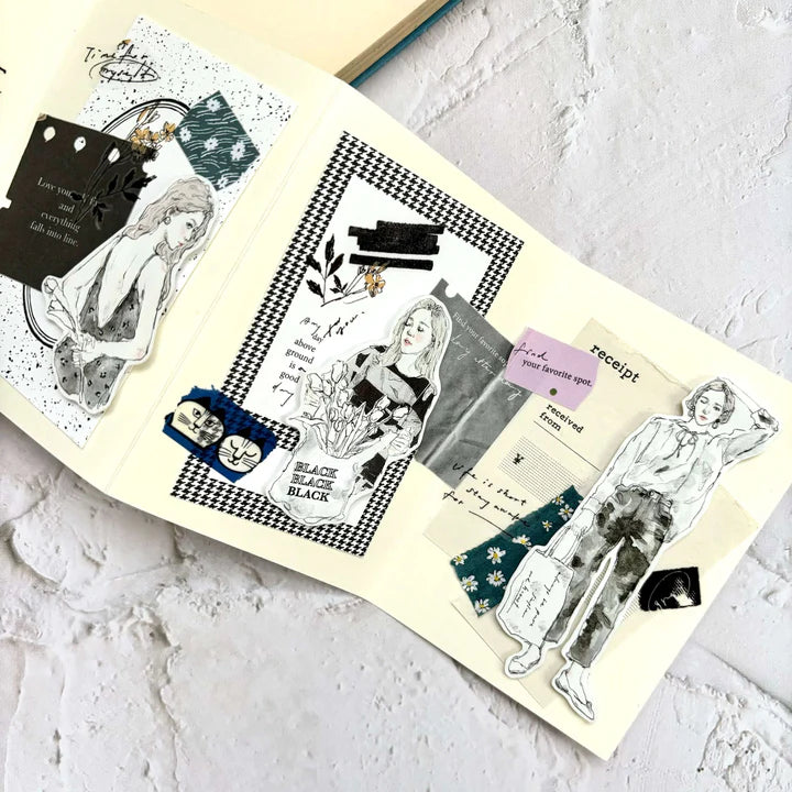 Open book styled with Label Paper Label Sticker Tape black and white drawings on a textured surface
