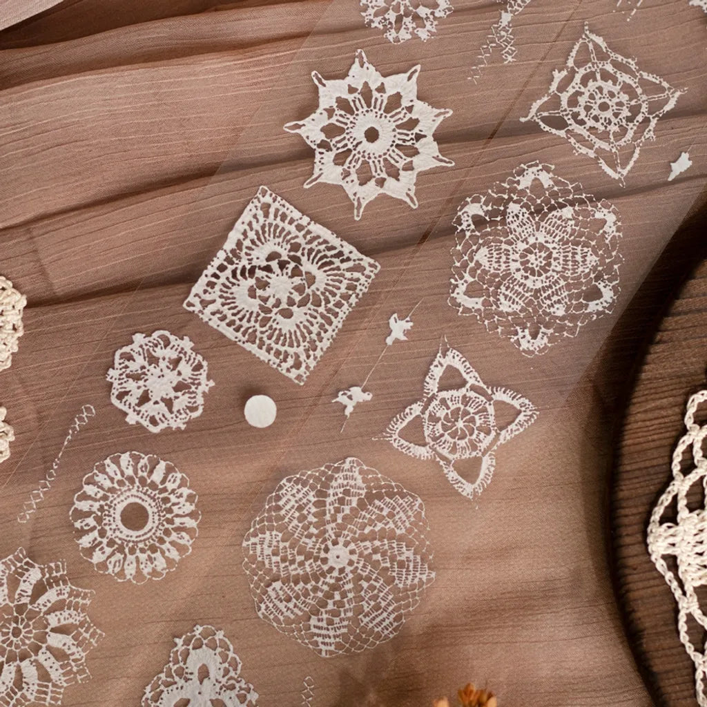 Lace PET Tape by Loidesign white lace patterns displayed on a brown fabric background