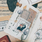 Collection of vintage-style cards with illustrations and text on a surface with music sheet background