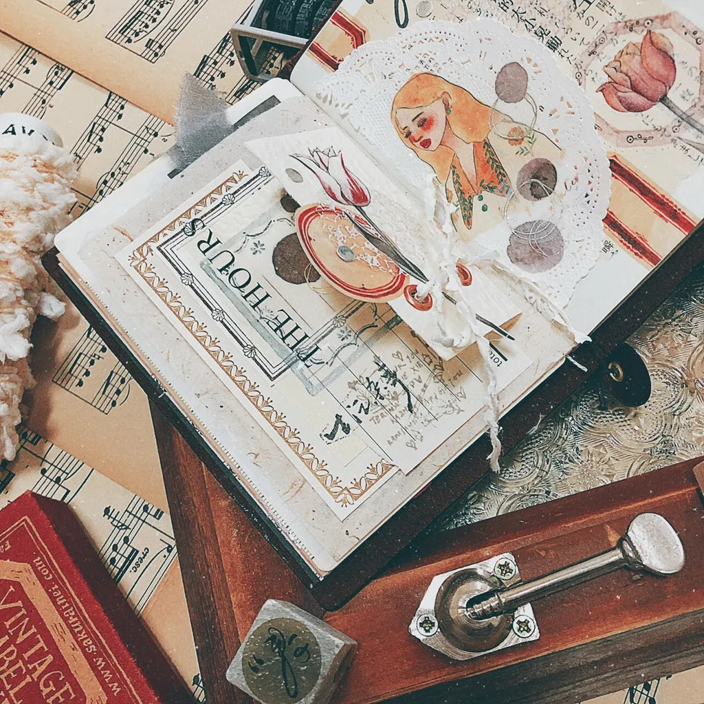 Open book with a Lace PET Tape woman and table-setting design among vintage items