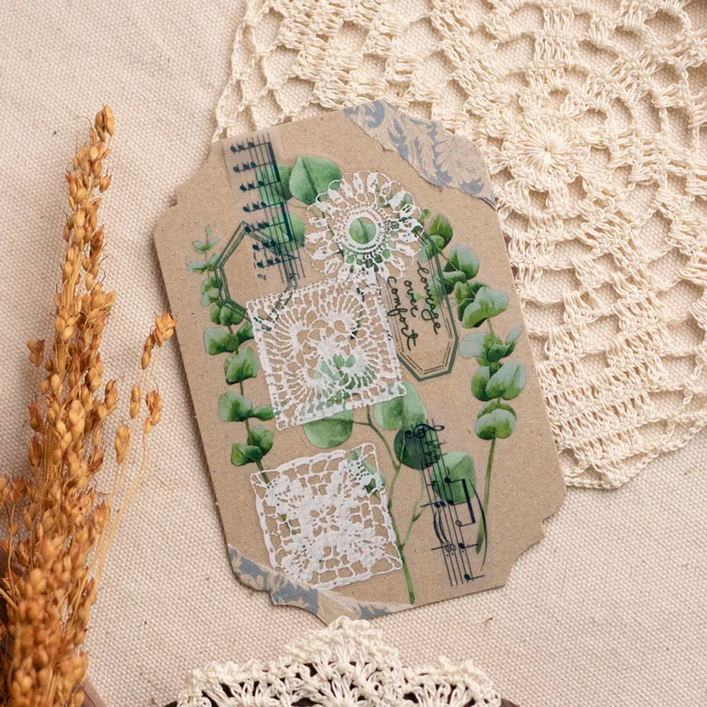 Paper tag decorated with Lace PET Tape lace and greenery designs on a textured surface