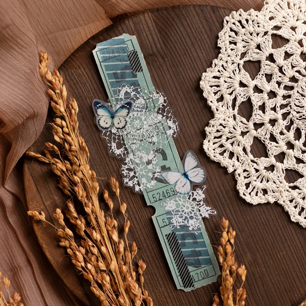 Watch styled with a Lace PET Tape butterfly design among lace and dried plants on wood