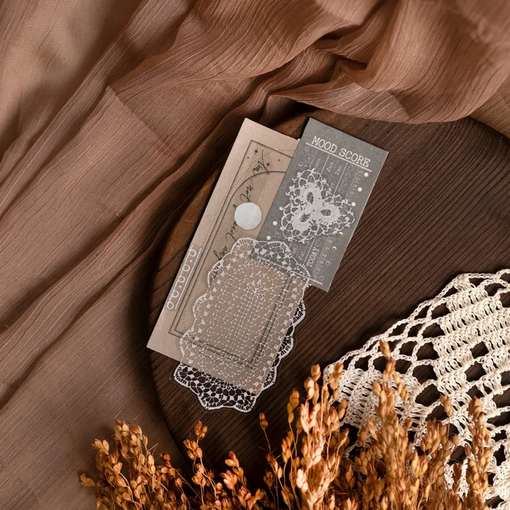 Card decorated with a Lace PET Tape design styled with fabric and dried flowers on wood