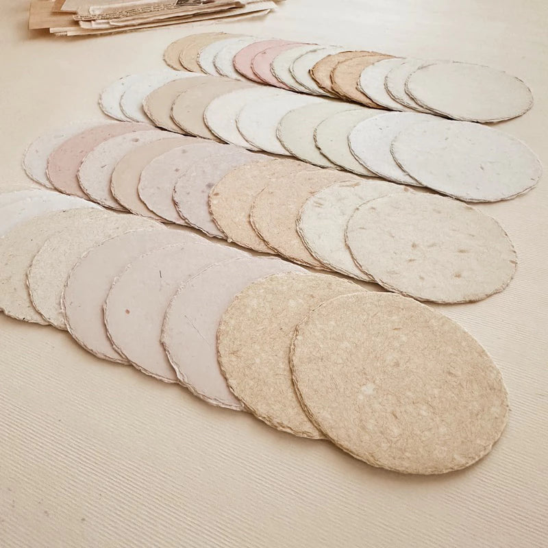 Full set of Large Circle Handmade Paper rounds displayed on a light wooden surface