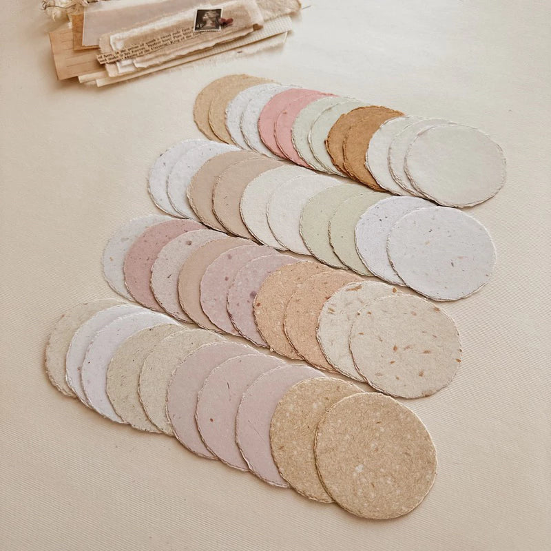 Set of round, beige-colored discs on a beige surface with a blurred background.